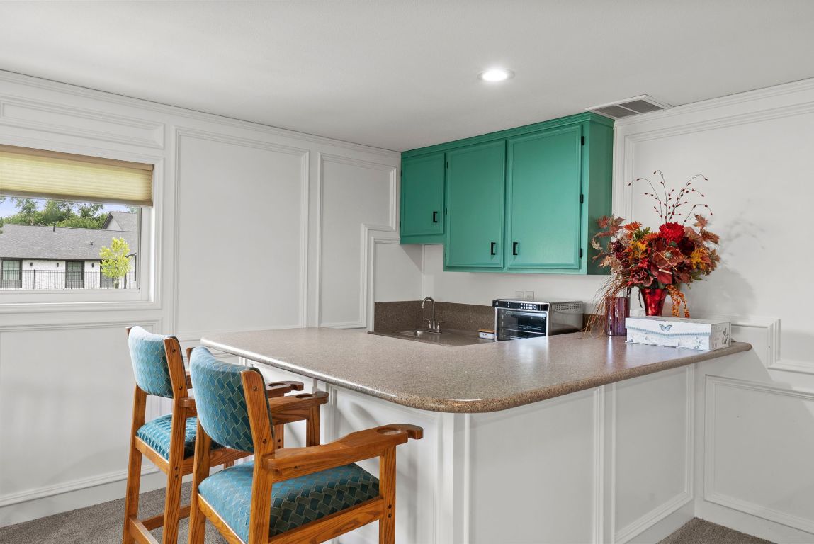 2702 Double Tree Street Round Rock, TX 78681 - Photo 18 of 35 a kitchen with kitchen island a sink table and chairs