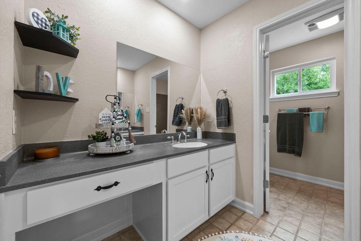 2702 Double Tree Street Round Rock, TX 78681 - Photo 26 of 35 a bath room with sink and mirror