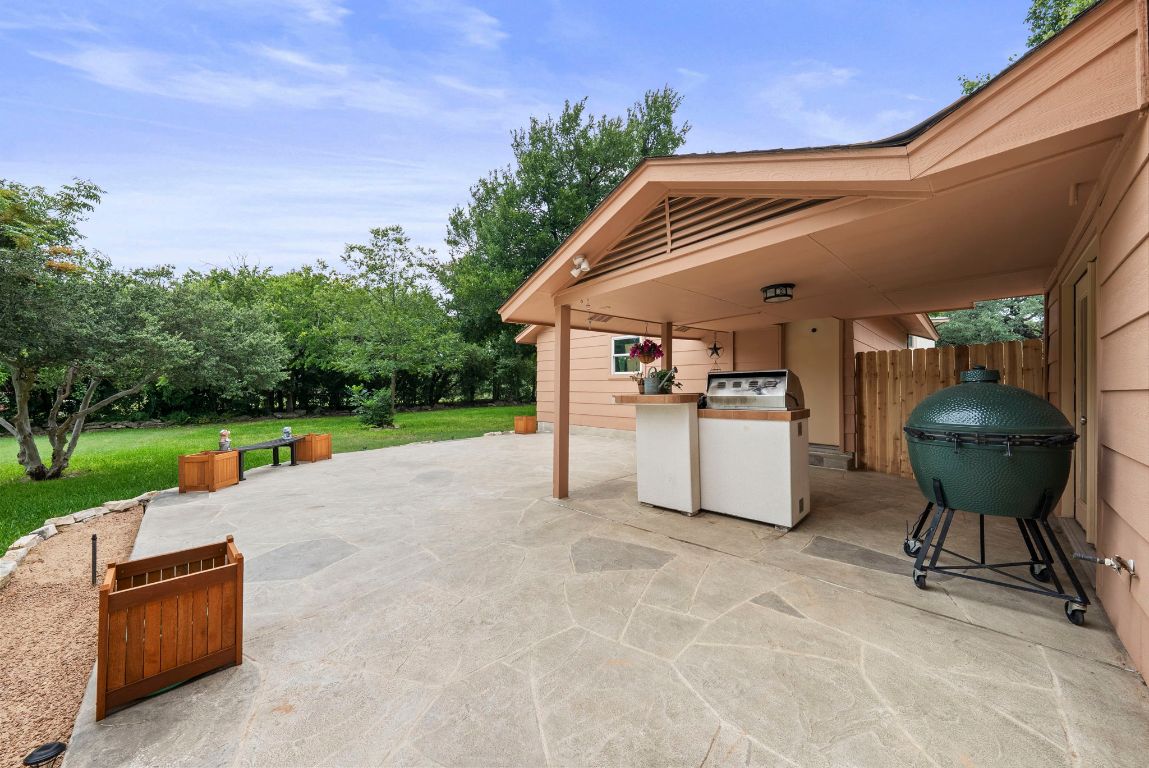 2702 Double Tree Street Round Rock, TX 78681 - Photo 31 of 35 a view of a backyard with table and chairs