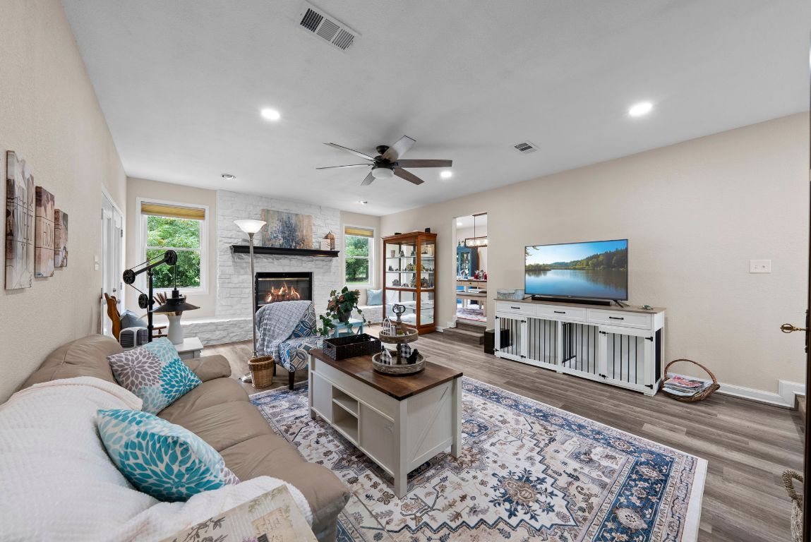 2702 Double Tree Street Round Rock, TX 78681 - Photo 7 of 35 a living room with furniture a flat screen tv and a fireplace