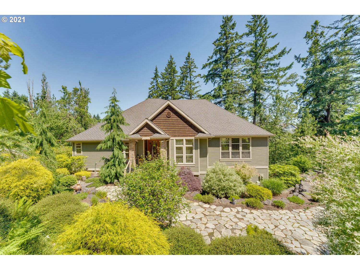 14683 Southeast Aldridge Road Happy Valley, OR 97086 - Photo 1 of 31 a front view of a house with a garden