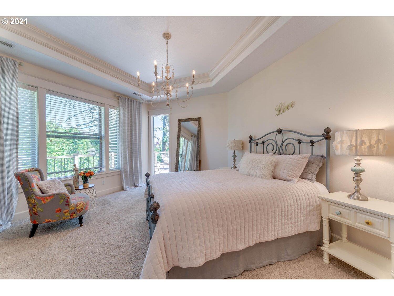 14683 Southeast Aldridge Road Happy Valley, OR 97086 - Photo 16 of 31 a spacious bedroom with a bed a couch and large windows