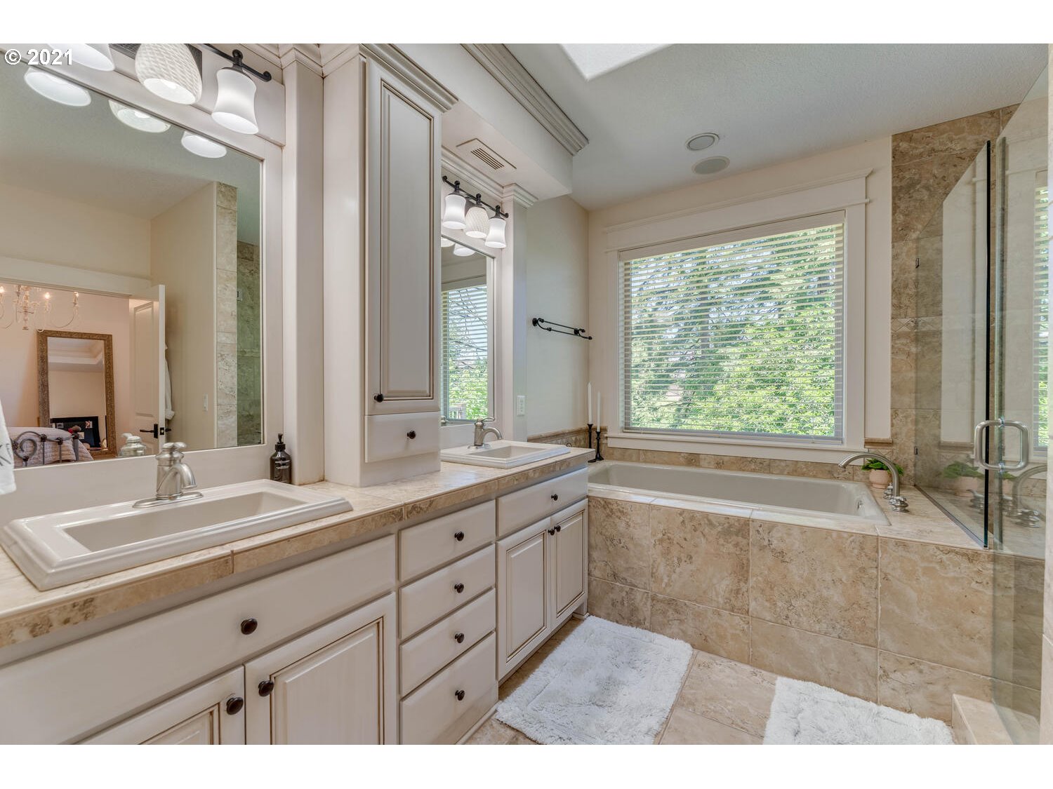 14683 Southeast Aldridge Road Happy Valley, OR 97086 - Photo 17 of 31 a spacious bathroom with a double vanity sink a large mirror a bathtub and next to a window