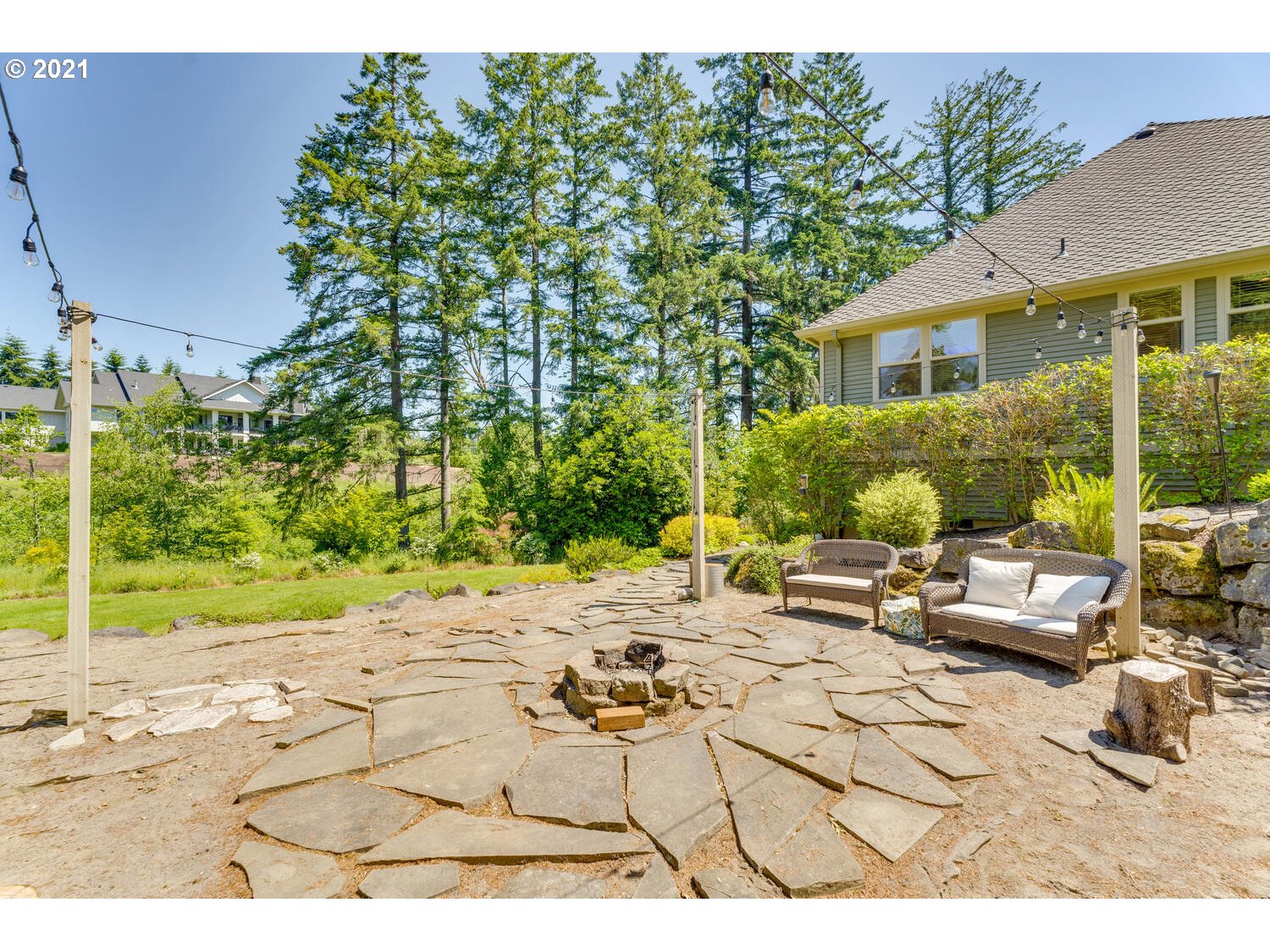 14683 Southeast Aldridge Road Happy Valley, OR 97086 - Photo 30 of 31 a view of a patio with couches and chairs under an umbrella