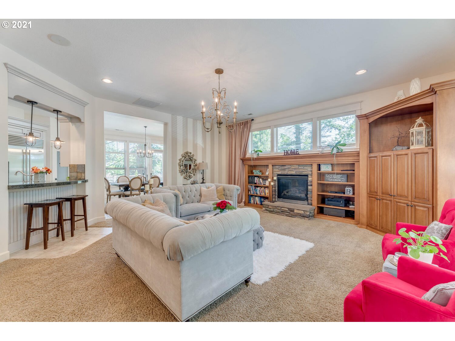 14683 Southeast Aldridge Road Happy Valley, OR 97086 - Photo 9 of 31 a living room with furniture a fireplace and a chandelier