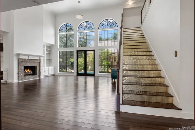 a view of front door with wooden floor and a fireplace