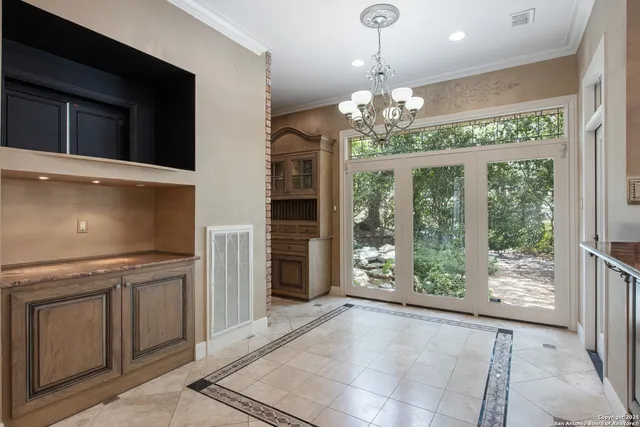 a view of a kitchen with a dishwasher cabinets and a floor to ceiling window