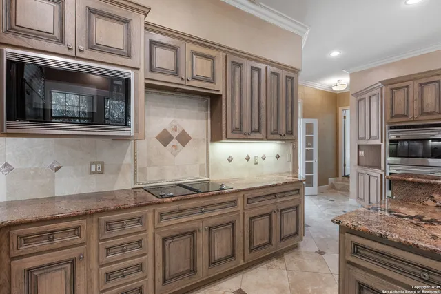 a kitchen with stainless steel appliances granite countertop a stove and cabinets