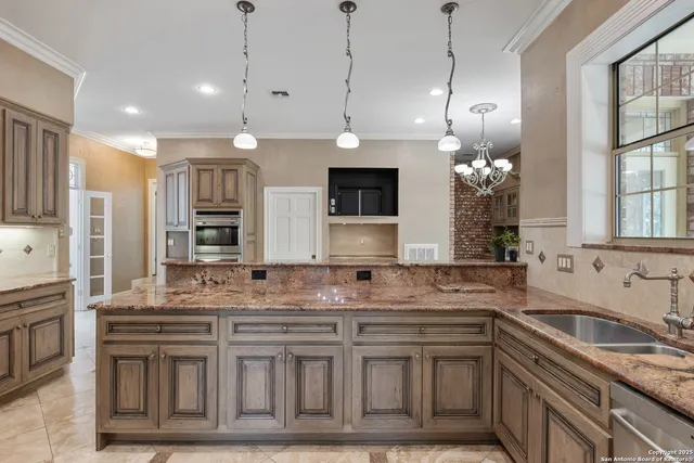 a kitchen with stainless steel appliances granite countertop a sink a stove and a granite counter tops