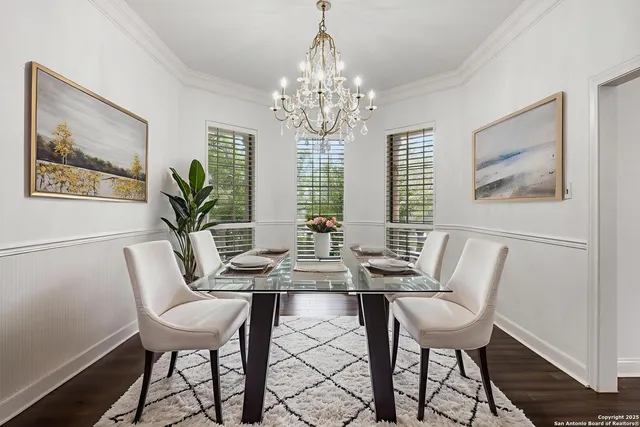 a view of a dining room with furniture a chandelier and wooden floor