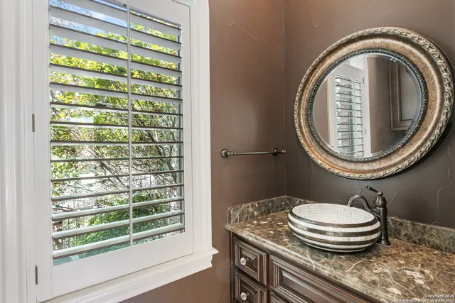 a bathroom with a sink a mirror and a toilet