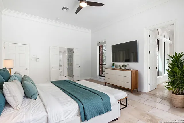 a bedroom with a bed and a flat screen tv