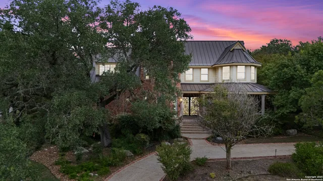 a front view of a house with a yard and garden