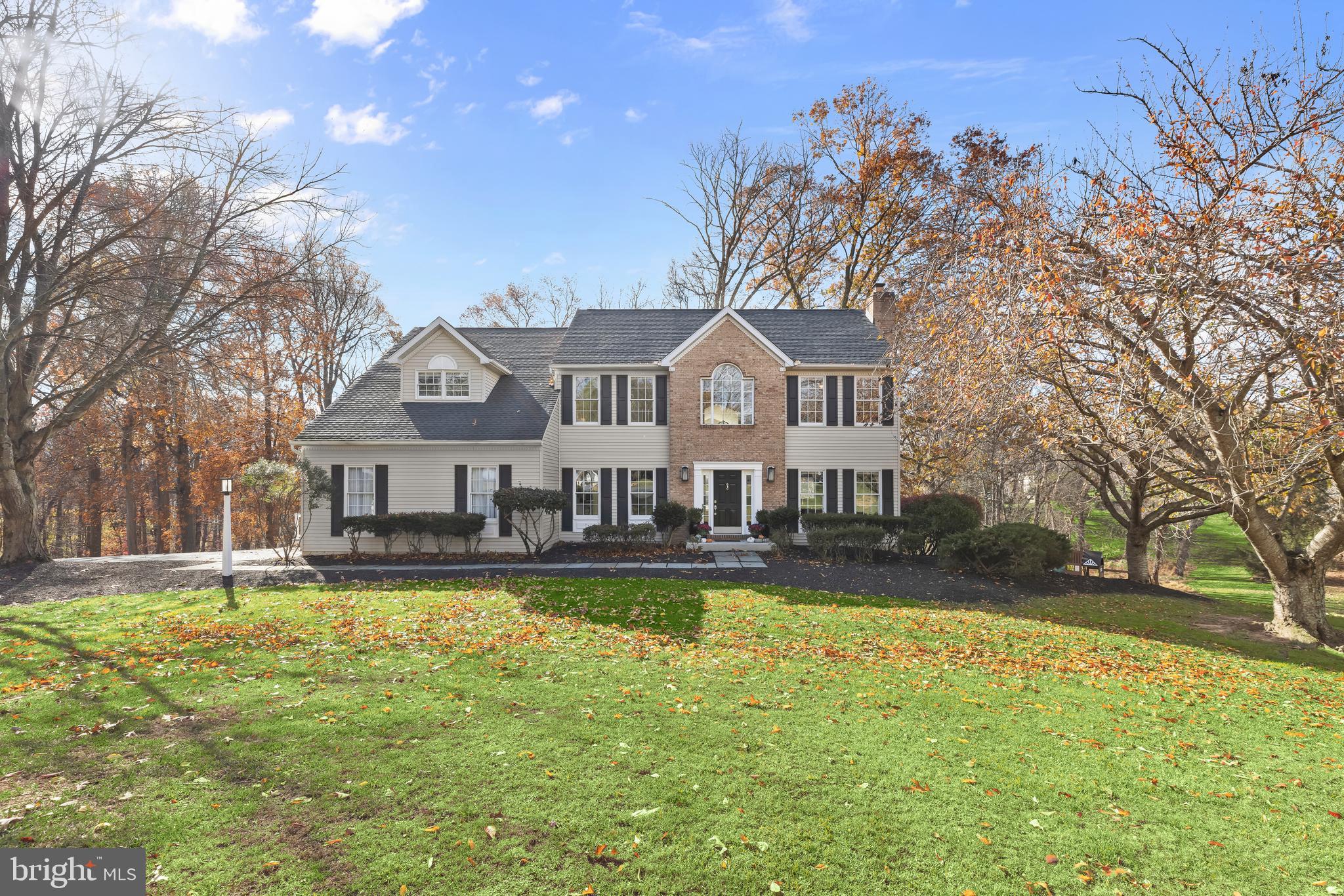 a front view of a house with swimming pool and porch with furniture
