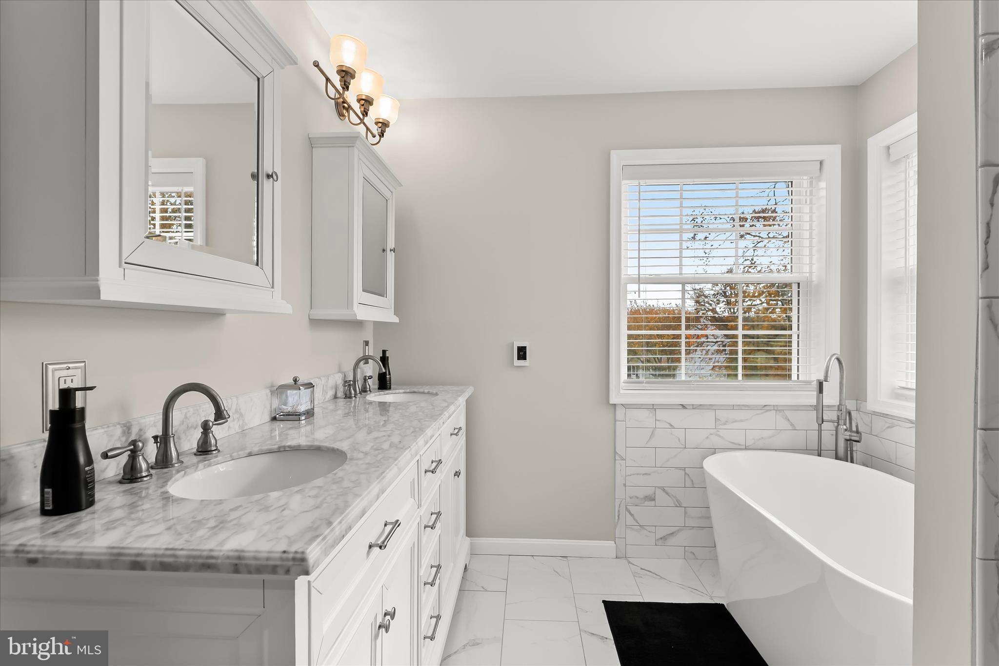 22 Farm Ridge Court Baldwin, MD 21013 - Photo 33 of 57 a bathroom with double vanity sink a bathtub and mirror