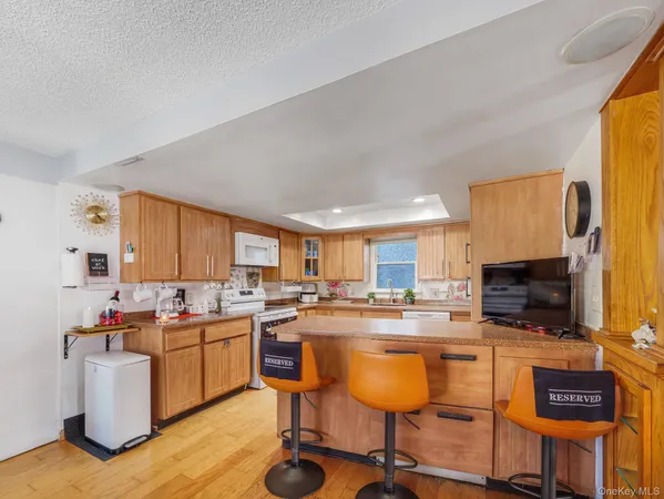 a kitchen with a sink a stove cabinets and a dining table