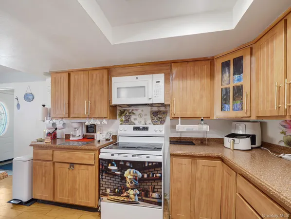 a kitchen with stainless steel appliances granite countertop a stove a sink dishwasher and cabinets with wooden floor