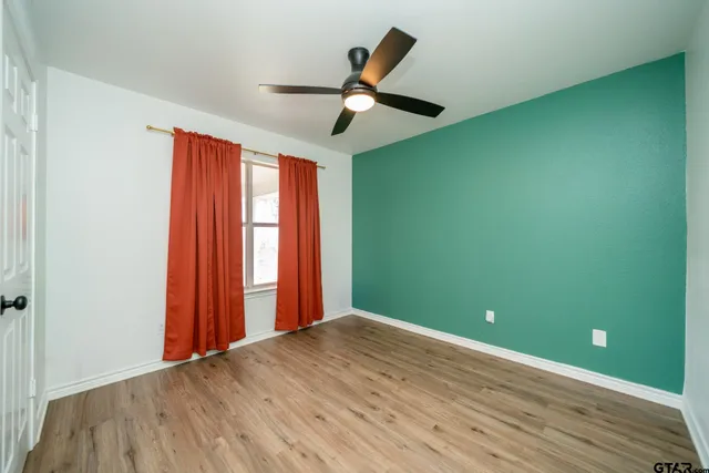 a view of room with window and ceiling fan