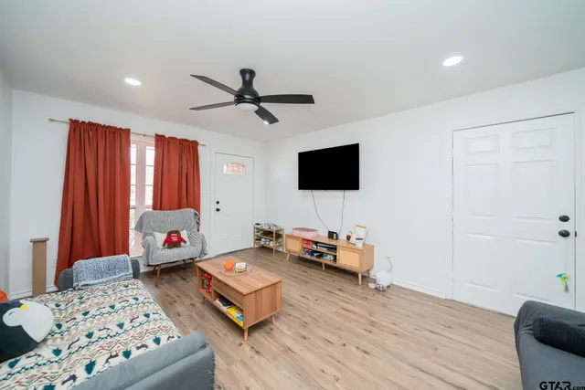 a bedroom with furniture and a flat screen tv