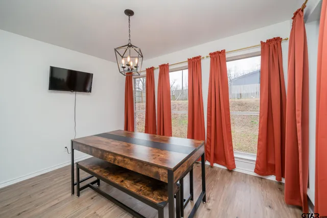 a view of a room with furniture wooden floor and window