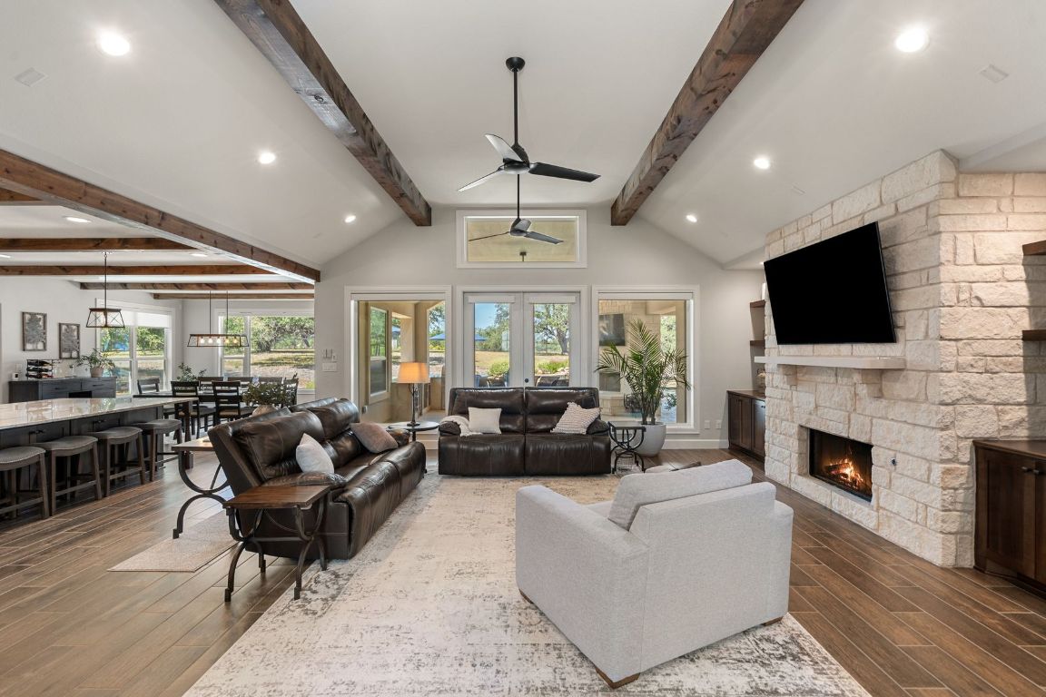 291 Southwick Ranch Road Johnson City, TX 78636 - Photo 12 of 40 Living room featuring recessed lighting, wood tile floors, a fireplace, and a ceiling fan