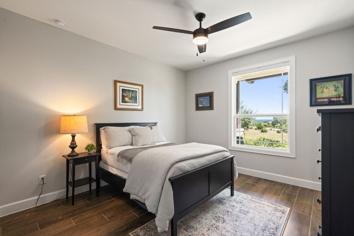 291 Southwick Ranch Road Johnson City, TX 78636 - Photo 22 of 40 Bedroom with wood tile floors and a ceiling fan