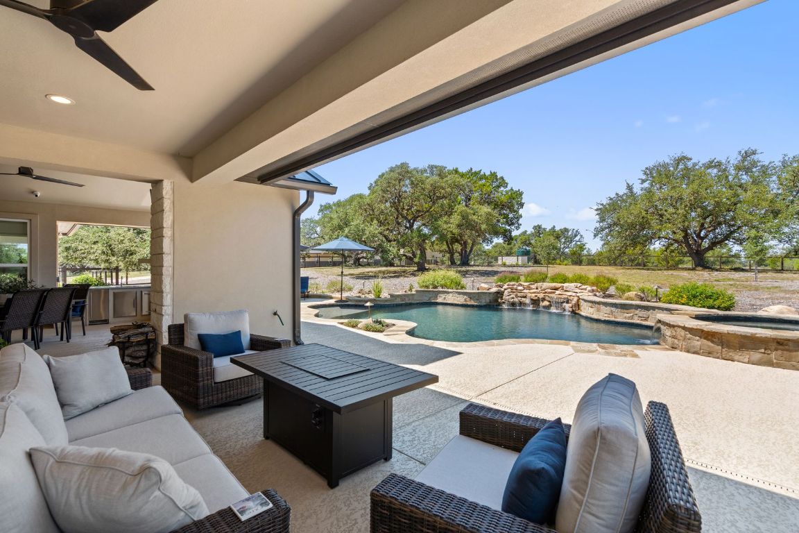 291 Southwick Ranch Road Johnson City, TX 78636 - Photo 31 of 40 View of patio / terrace with an outdoor living space, ceiling fan, and a pool with spa