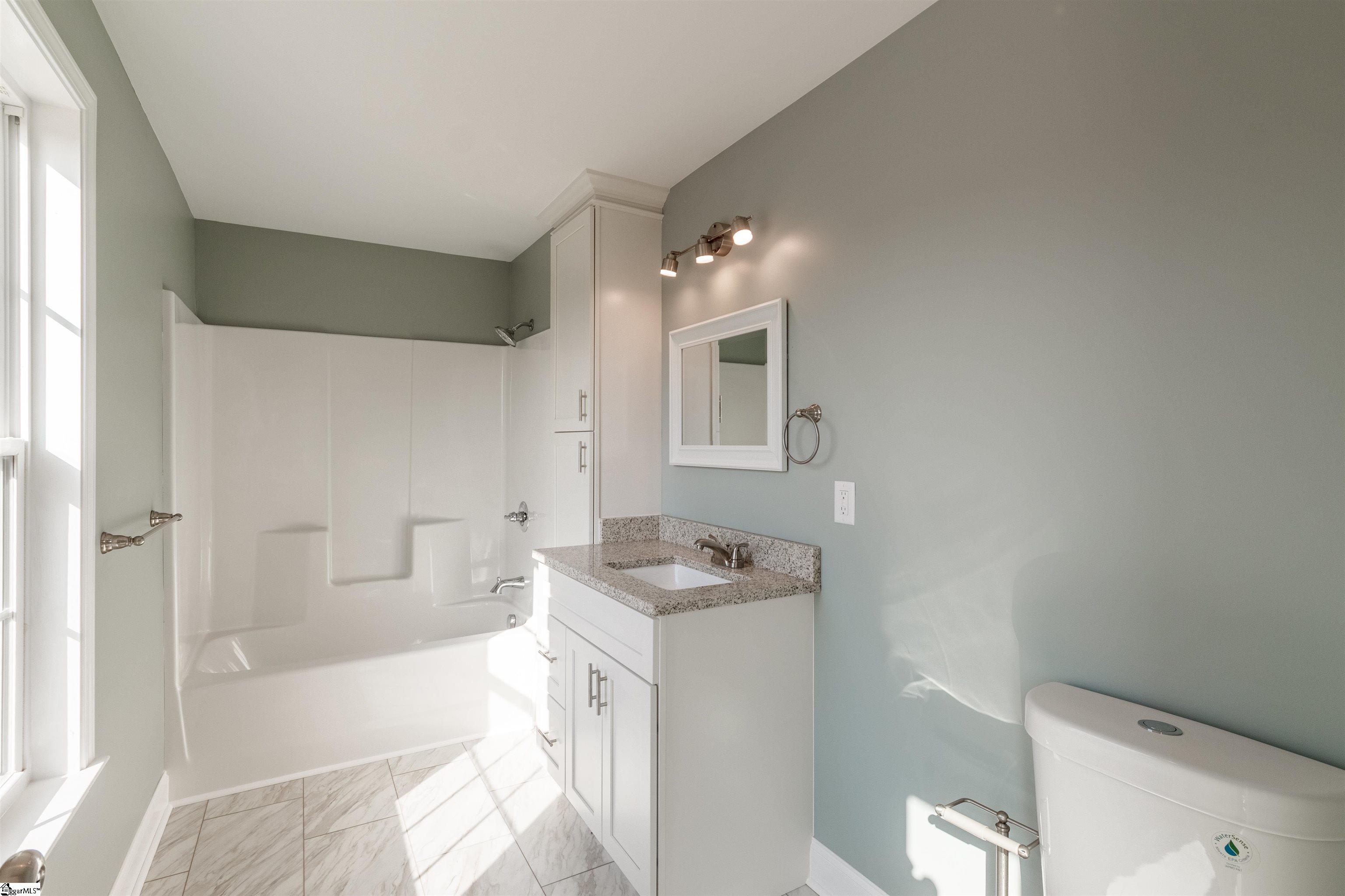 4 Maple Street Startex, SC 29377 - Photo 12 of 35 Conveniently located on the main level, the full bath is well appointed with tile floors, new vanity, granite countertops, and built in tub/shower.