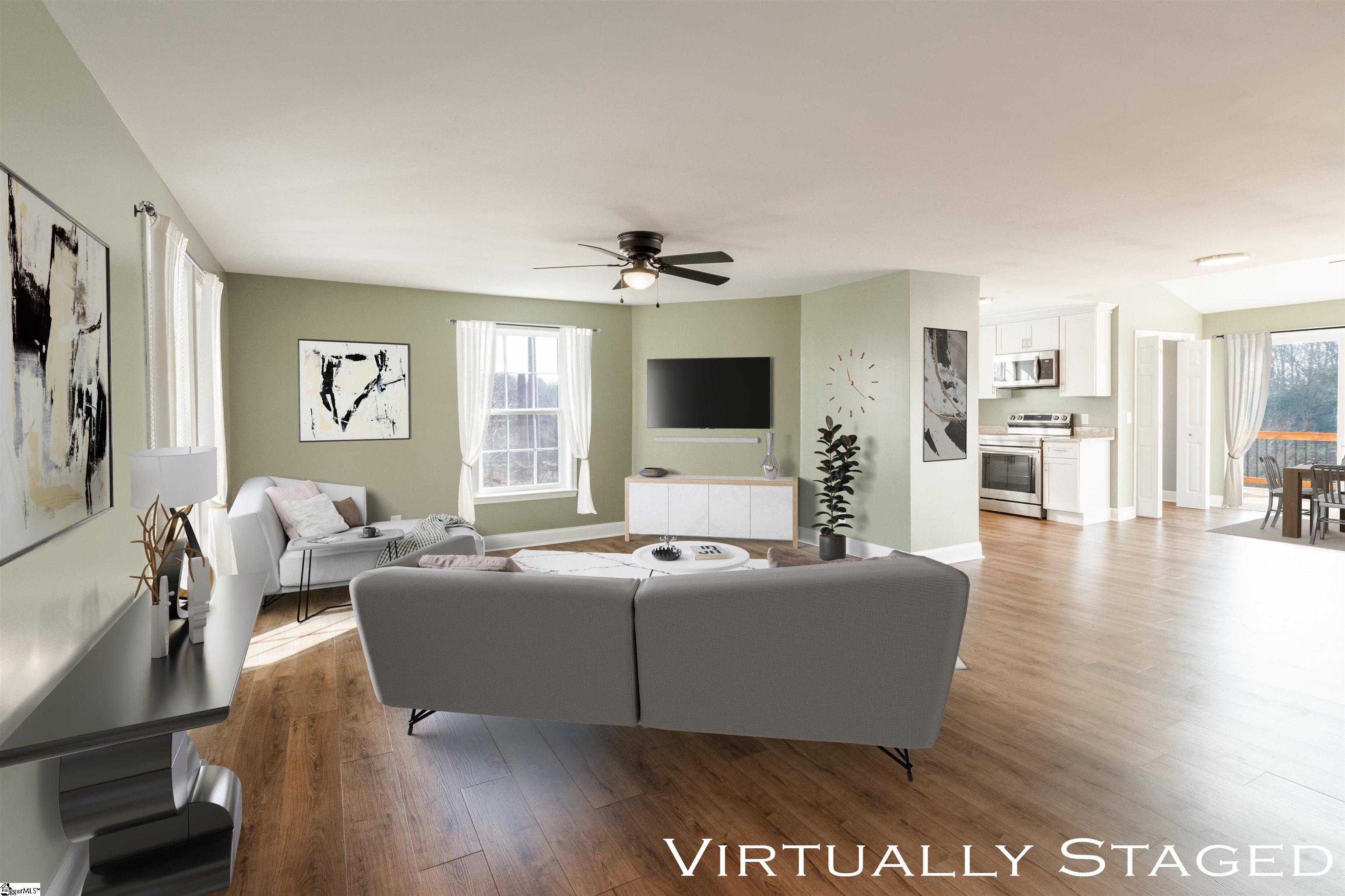 4 Maple Street Startex, SC 29377 - Photo 6 of 35 As you enter through double doors, enjoy sightlines past the spacious living room, the kitchen, and the dining area out onto the rear deck.