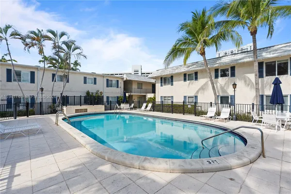 a view of a house with swimming pool and sitting area