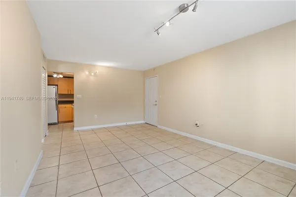 a view of an empty room and a window