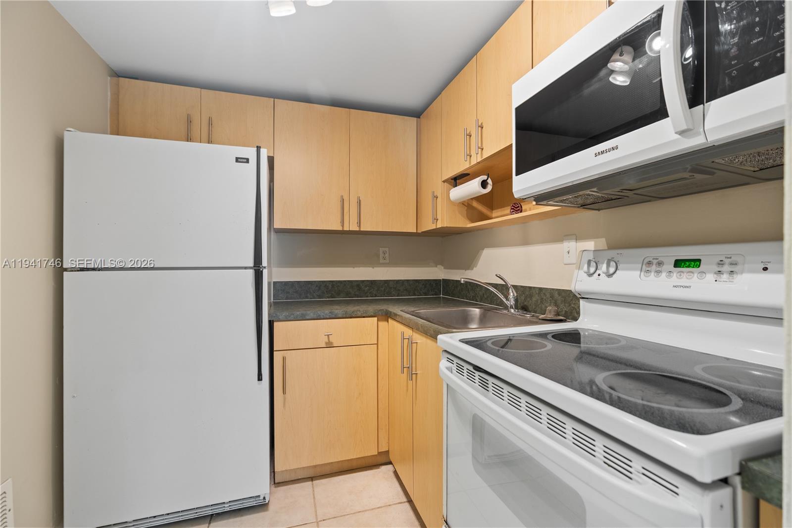 8607 Southwest 68th Court, Unit 5 Pinecrest, FL 33156 - Photo 5 of 12 a utility room with dryer and washer