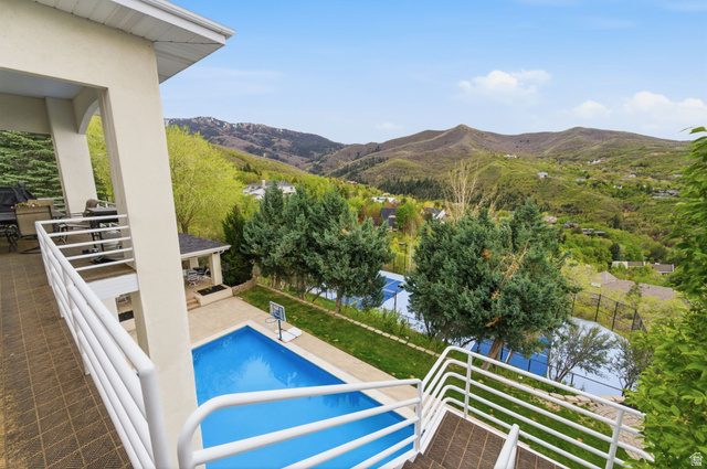1878 East Ridge Point Drive Bountiful, UT 84010 - Photo 61 of 92 View of swimming pool featuring a mountain view, patio surround, and a fenced backyard