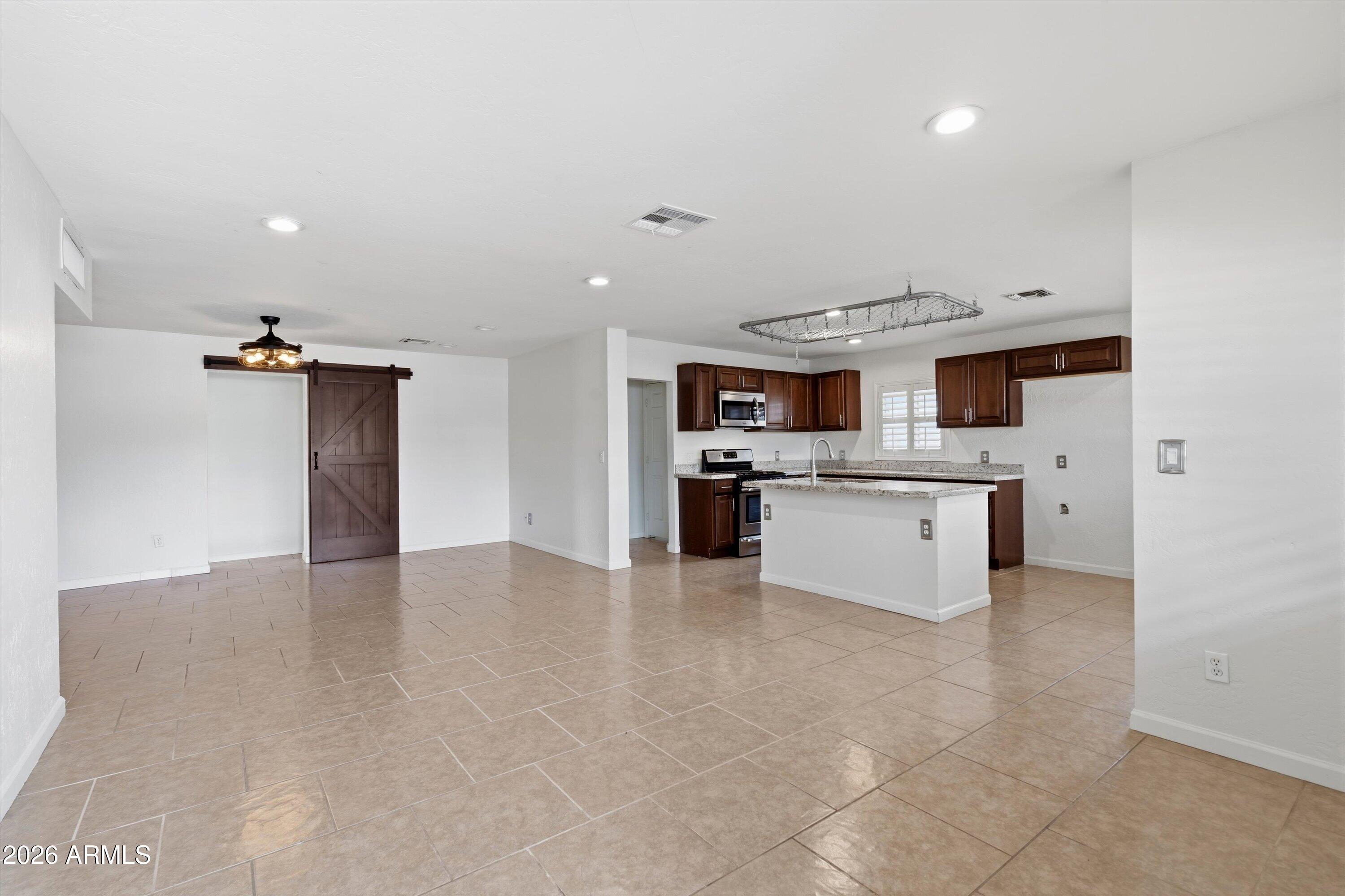6246 North 23rd Avenue Phoenix, AZ 85015 - Photo 1 of 30 a kitchen with stainless steel appliances a refrigerator sink and cabinets