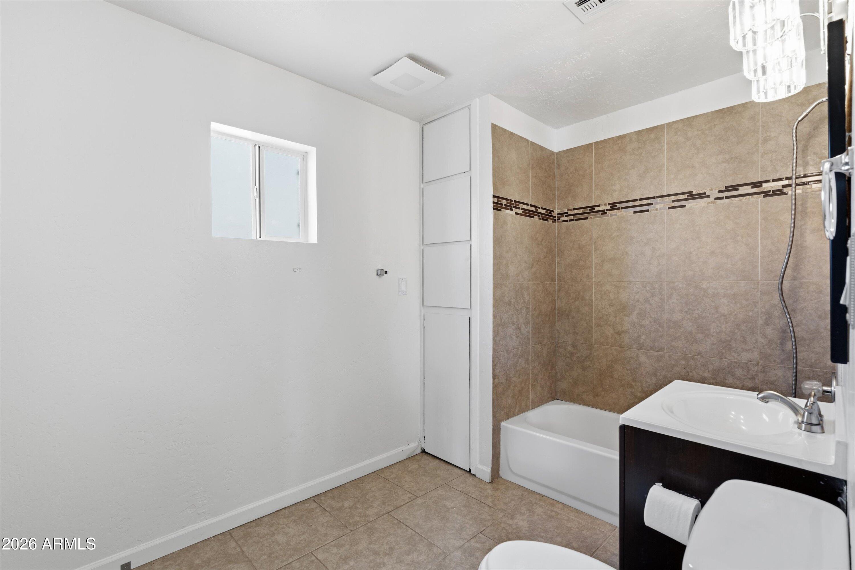 6246 North 23rd Avenue Phoenix, AZ 85015 - Photo 16 of 30 a bathroom with a sink a toilet a shower and a mirror