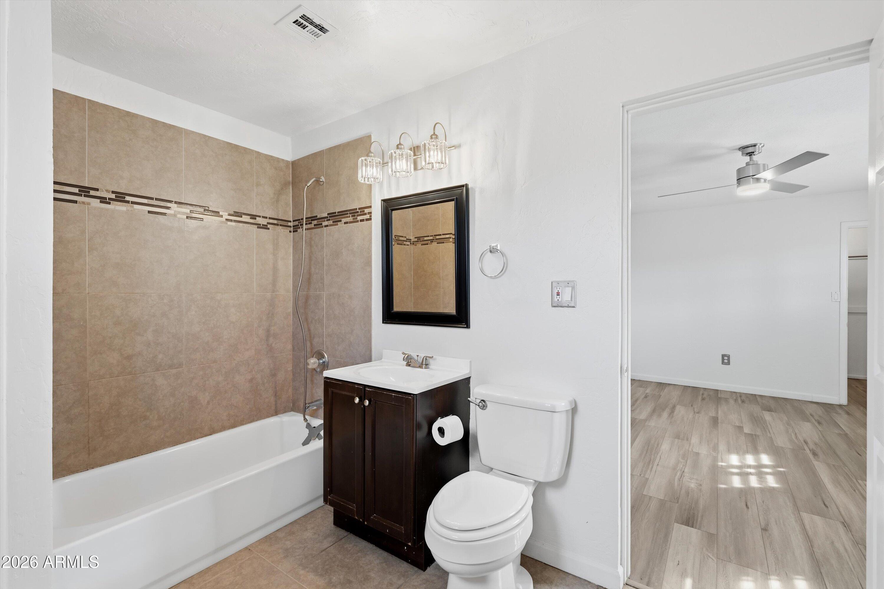 6246 North 23rd Avenue Phoenix, AZ 85015 - Photo 17 of 30 a bathroom with a toilet a sink and bathtub