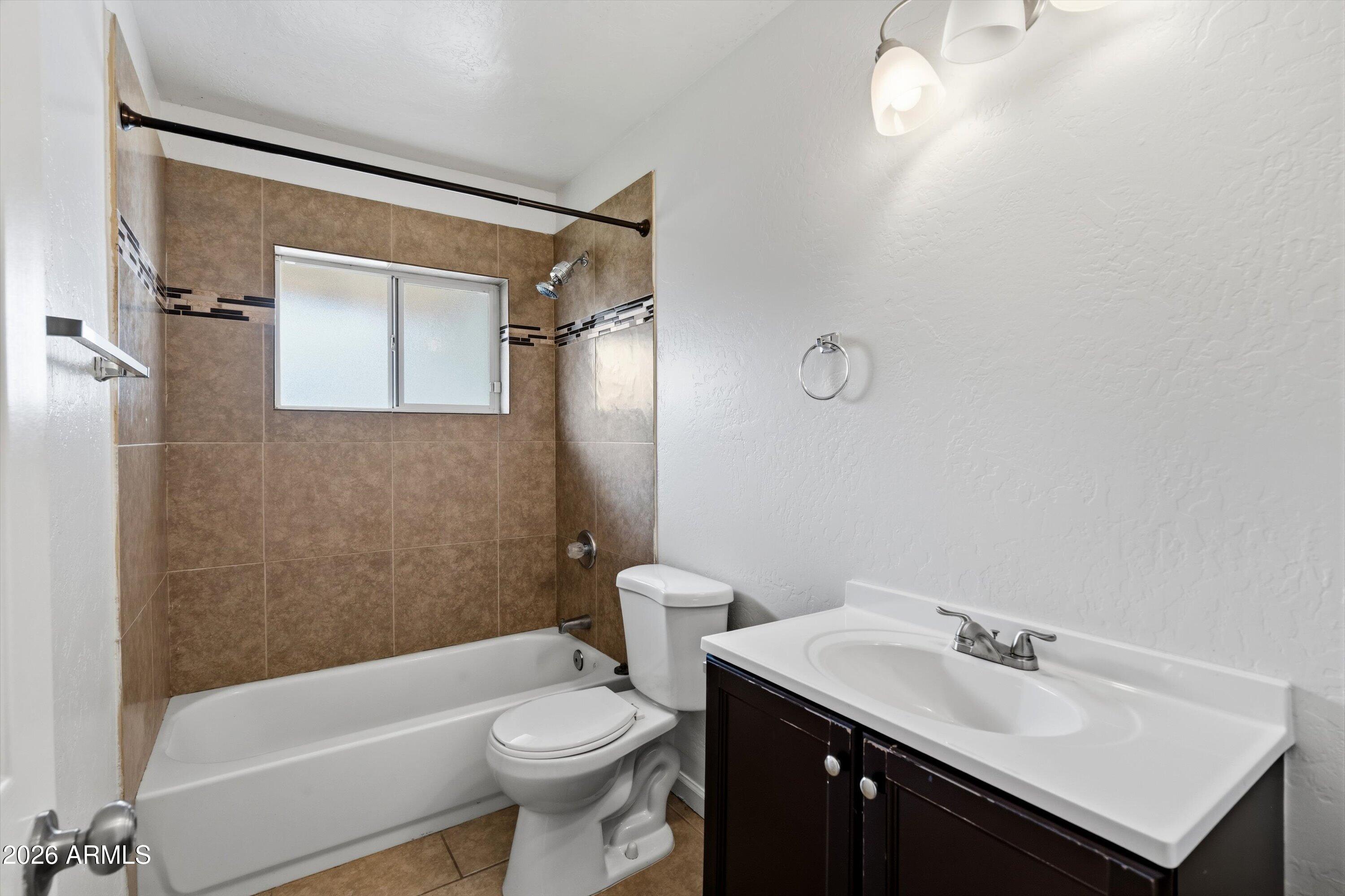 6246 North 23rd Avenue Phoenix, AZ 85015 - Photo 19 of 30 a bathroom with a sink a toilet and shower