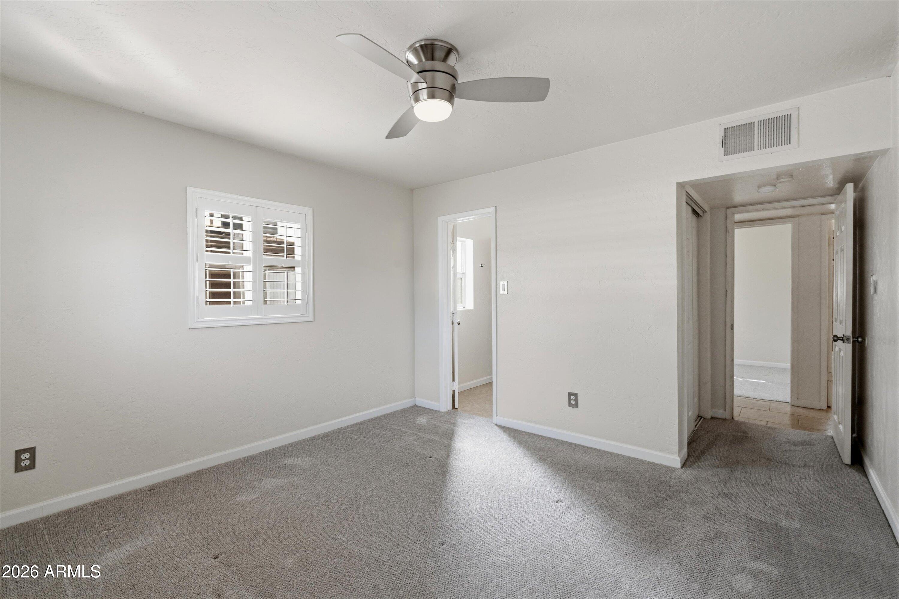 6246 North 23rd Avenue Phoenix, AZ 85015 - Photo 20 of 30 a view of a big room with chandelier fan and windows