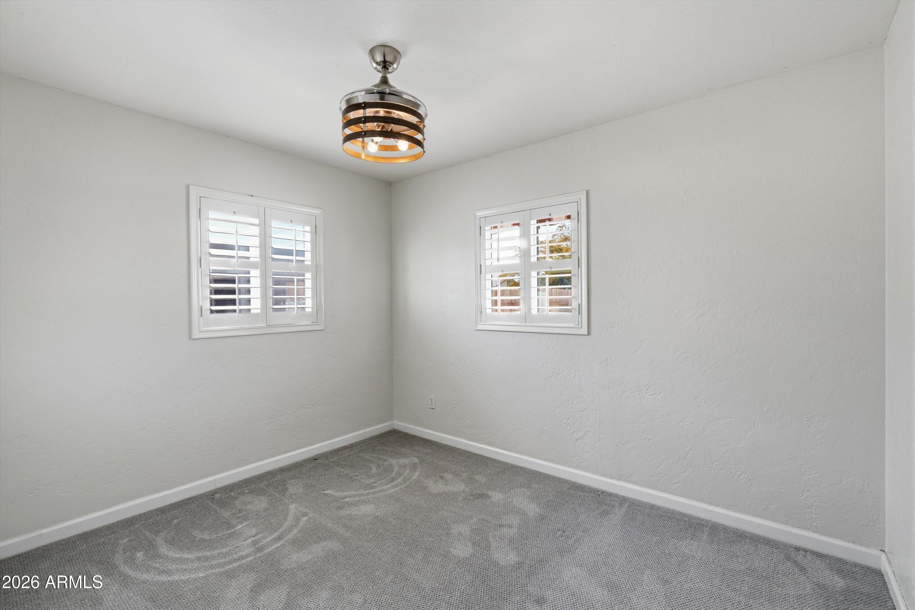 6246 North 23rd Avenue Phoenix, AZ 85015 - Photo 22 of 30 an empty room with windows