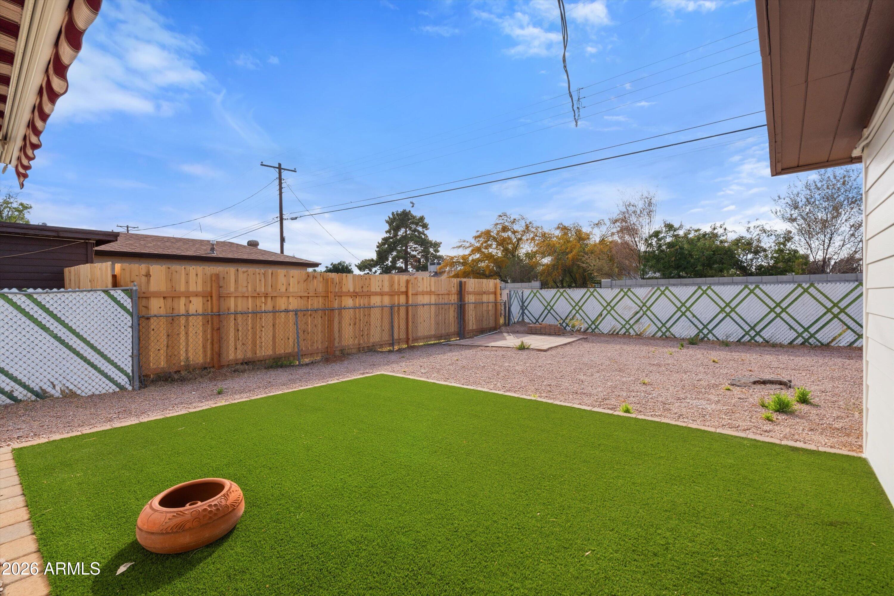 6246 North 23rd Avenue Phoenix, AZ 85015 - Photo 27 of 30 a view of a backyard with a table and chair