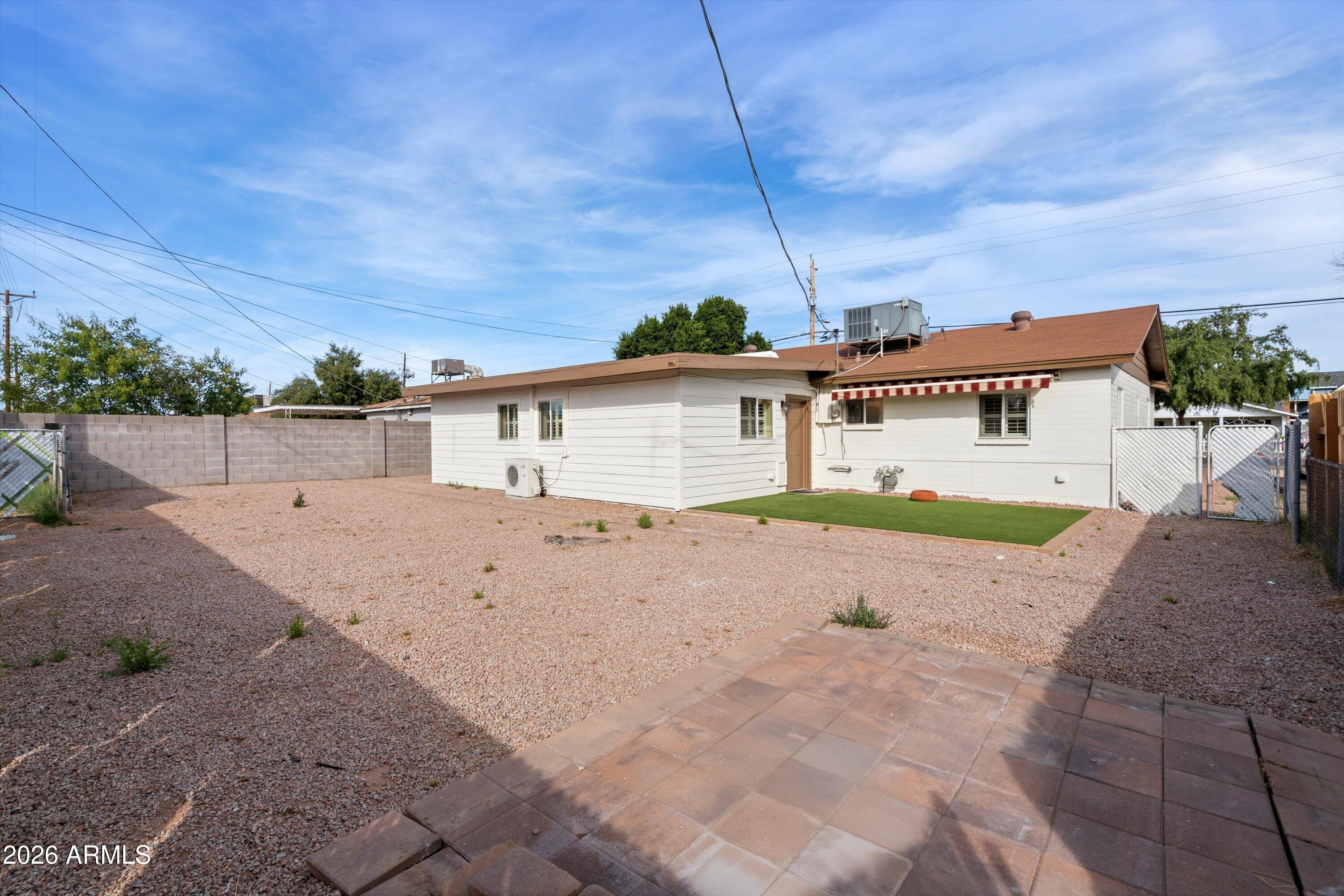 6246 North 23rd Avenue Phoenix, AZ 85015 - Photo 28 of 30 a view of a house with a backyard and a garage