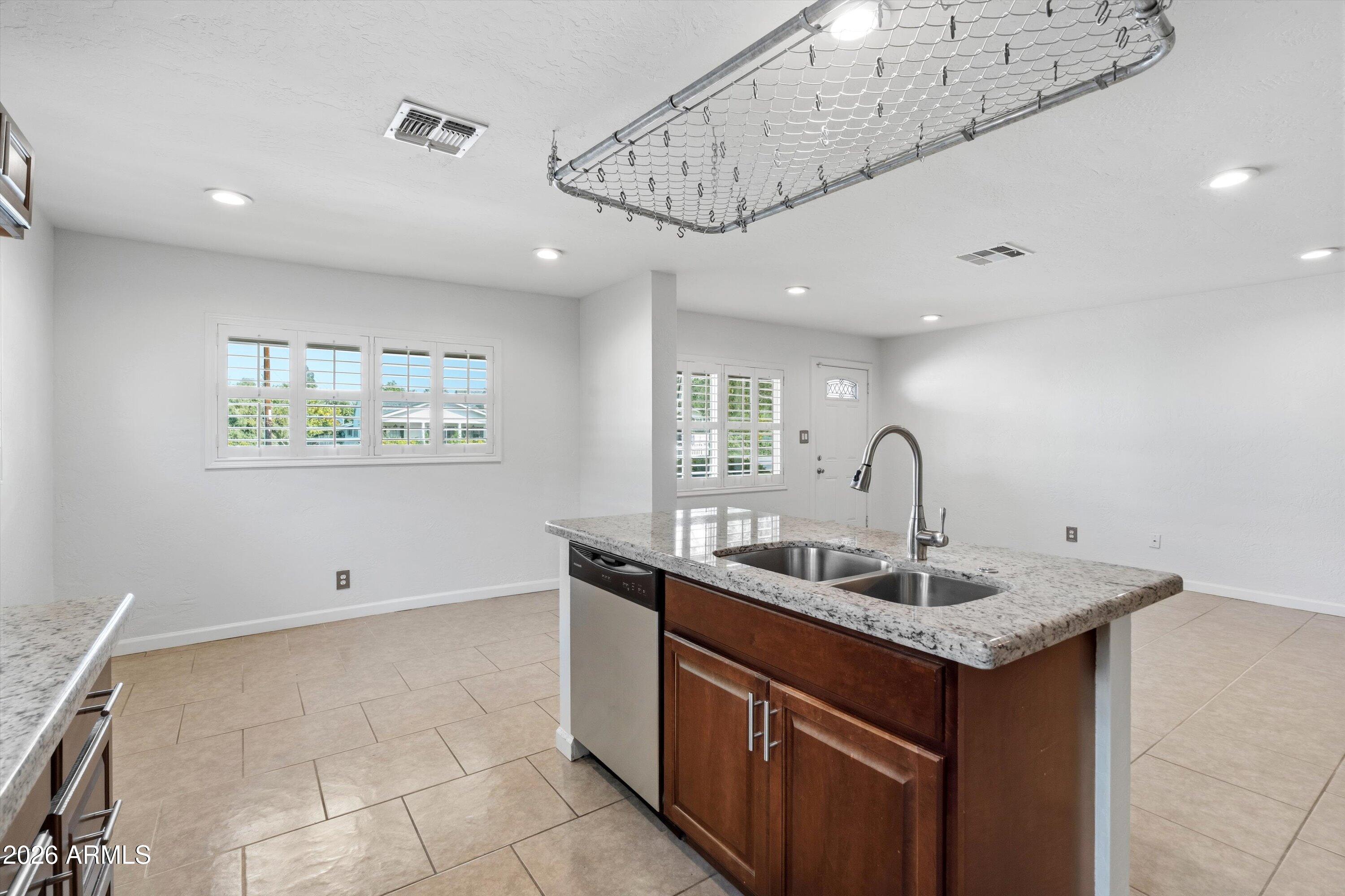 6246 North 23rd Avenue Phoenix, AZ 85015 - Photo 6 of 30 a kitchen with a sink and cabinets