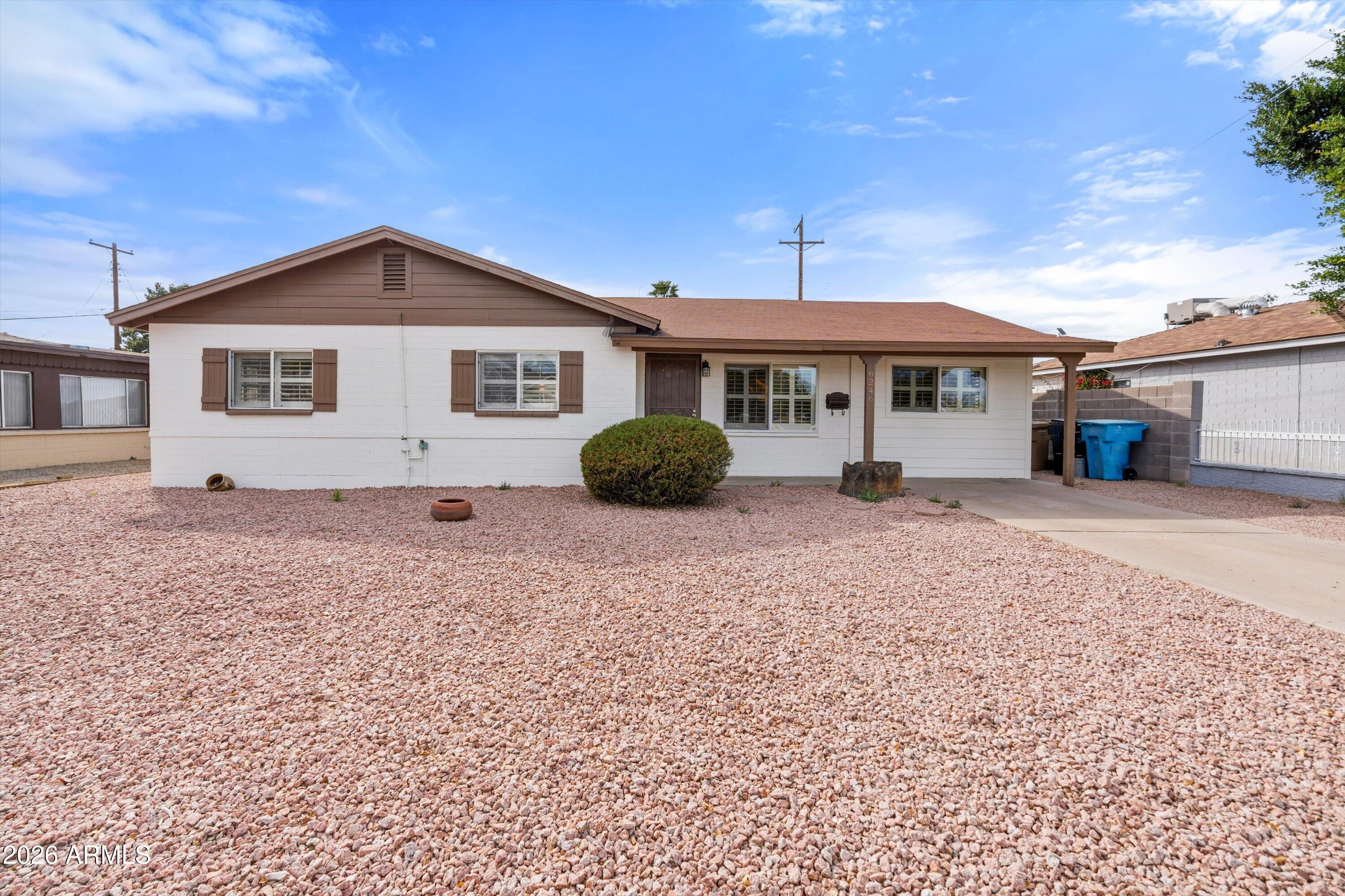 6246 North 23rd Avenue Phoenix, AZ 85015 - Photo 10 of 30 a front view of a house with a yard