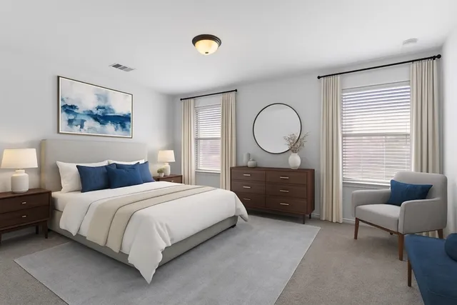 a bedroom with a bed a couch and a window