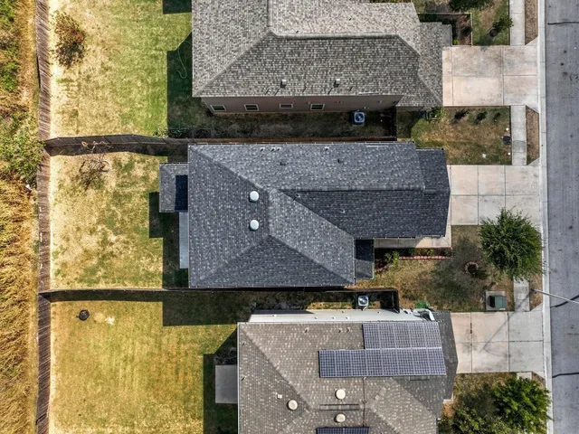 an aerial view of a house with a yard