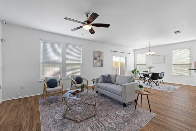 a living room with furniture and wooden floor