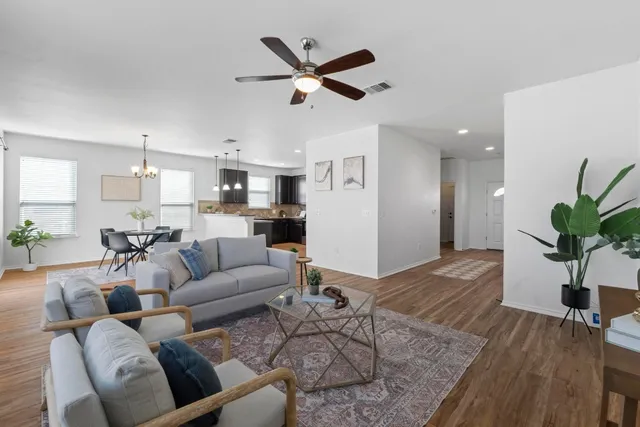 a living room with furniture and kitchen view
