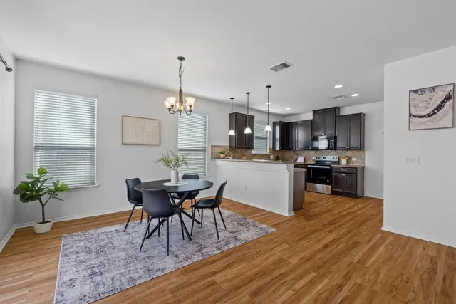 a kitchen with a table and chairs in it