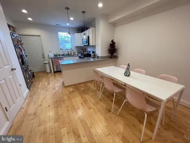 a kitchen with a sink cabinets and wooden floor