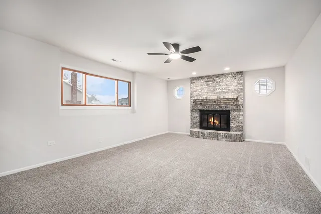 a view of empty room with a fireplace
